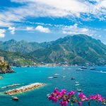 Amalfin upea rannikko jossa turkoosi meri sekä rannikon kiemurteleva serpentiini tie.