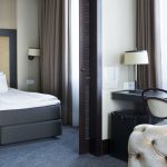 Comfort Hotel LT:n sviitin makuuhuone liukuovien takana