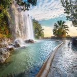 Vesiputous ja näköalatasanne ilta-auringossa.