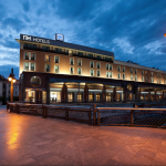 Hotelli ulkoa kuvattuna iltavalaistuksessa