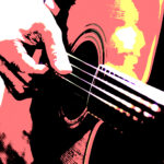 Mies soittaa kitaraa.