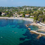 Aerial view of Ondes Beach on the Cap d'Antibes in the French Riviera - Ruins of a flooded round watch tower in the Mediterranean Sea