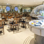 Ravintolasali, jossa paljon pöytiä ja tuoleja